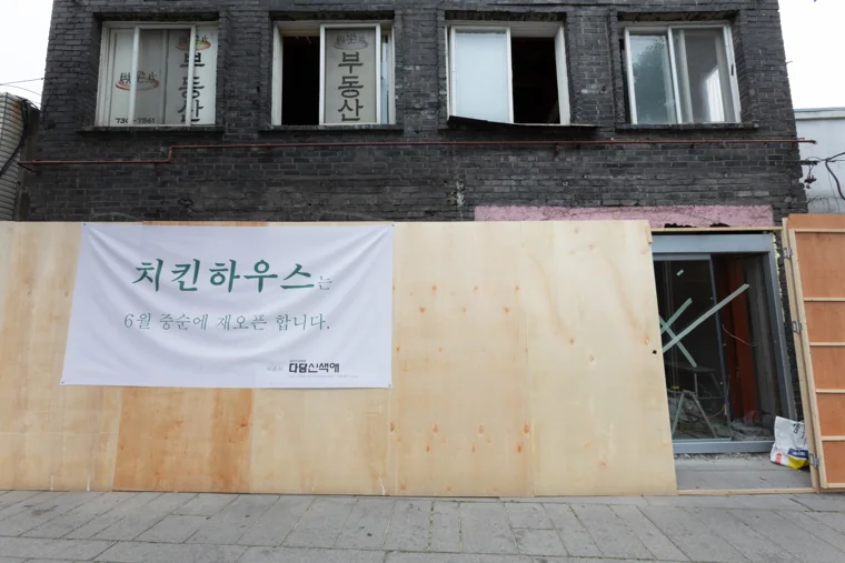 가림막과 출입구를 정면에서 담은 시공 기간의 외부 모습.